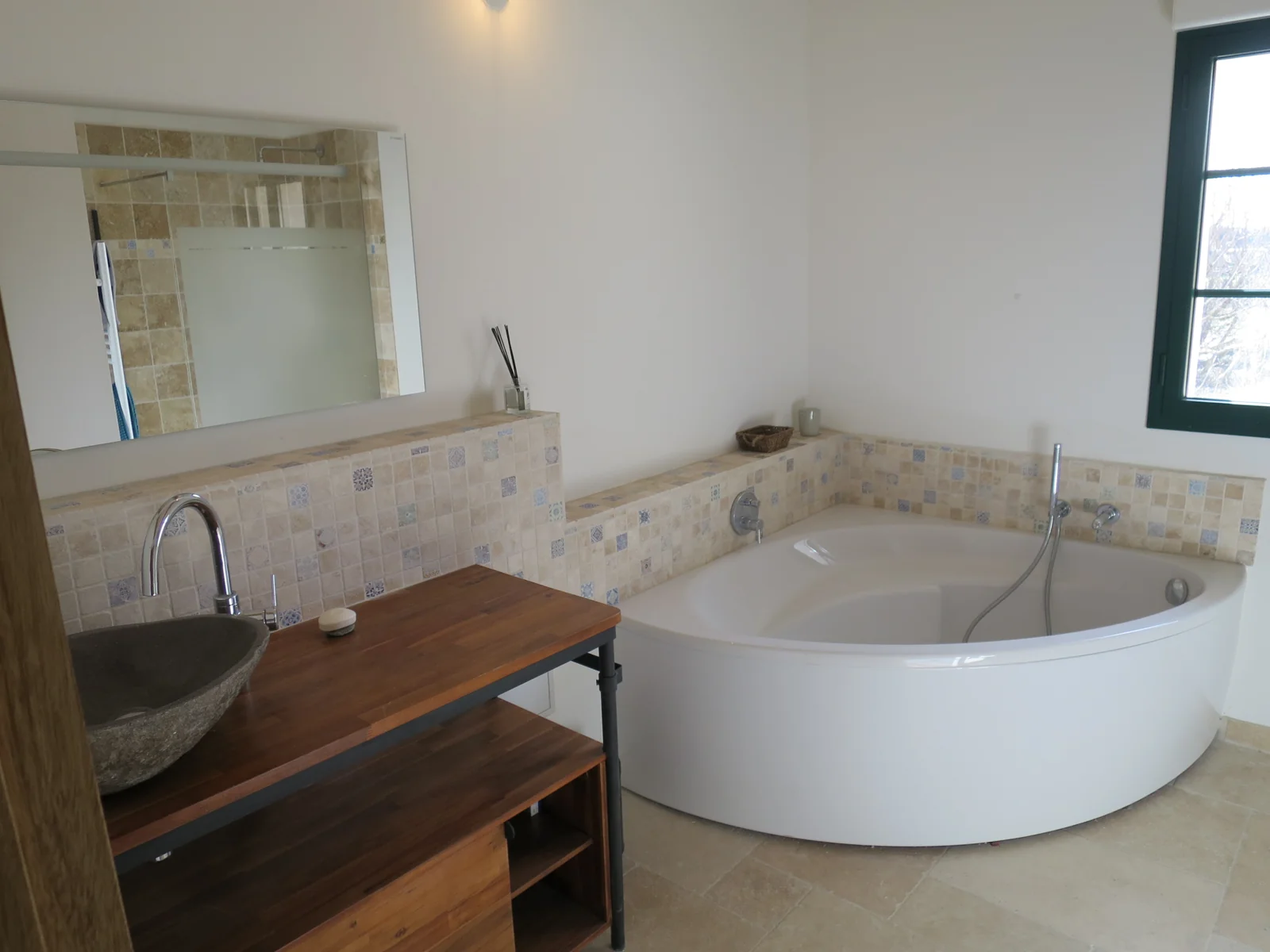 Salle de bain du mas, baignoire et bois sous une poutre apparente
